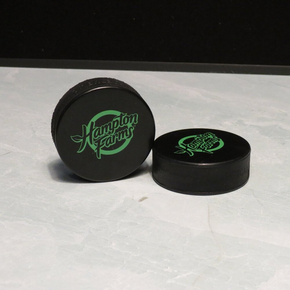 Lot of 2 Hampton Farms Hockey Pucks